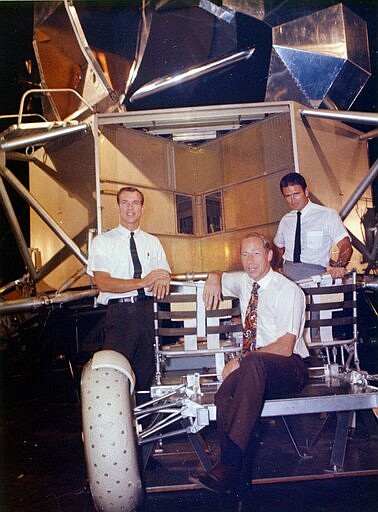 This undated photo made available by NASA shows astronauts Al Worden, center, Dave Scott, left, and Jim Irwin with a moon rover mock-up. Worden, who circled the moon alone in 1971 while his two crewmates tried out the first lunar rover, has died at age 88, his family said Wednesday, March 18, 2020. (NASA via AP)