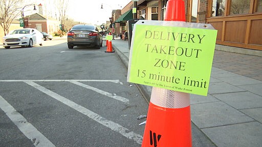 A sign stands outside White Street Brewing Company in Wake Forest, N.C., on Tuesday, March 17, 2020. With bars ordered close due to coronavirus, brewers are making sure their customers can enjoy some fresh suds. (AP Photo/Allen G. Breed)