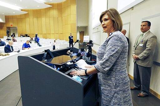 Dr. LouAnn Woodward, vice chancellor for health affairs and dean of the School of Medicine at the University of Mississippi Medical Center, speaks about the teaching hospital's readiness for dealing with the COVID-19 outbreak, in Jackson, Miss., Wednesday, March 18, 2020. Also attending the news update were the a number of the school and medical center's staff and administrators. (AP Photo/Rogelio V. Solis)