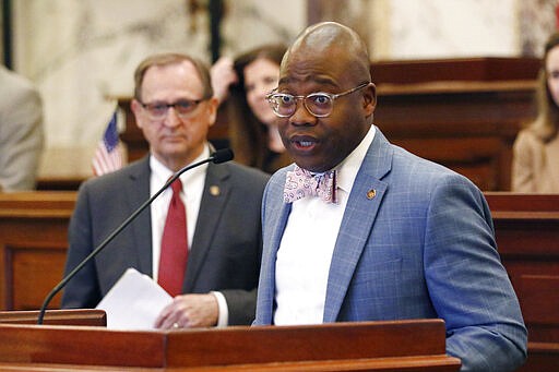 State Sen. Derrick Simmons, D-Greenville, speaks in support of a concurrent resolution suspending the legislators work until at least April 1, largely to prevent interaction among thousands of people who converge on the Capitol during most days of legislative sessions as President Pro Tempore Dean Kirby, R-Clinton looks on, at the Capitol in Jackson, Miss., Wednesday, March 18, 2020. The resolution passed and the body adjourned. The lieutenant governor and speaker of the House may delay a return to the Capitol at their own discretion. (AP Photo/Rogelio V. Solis)