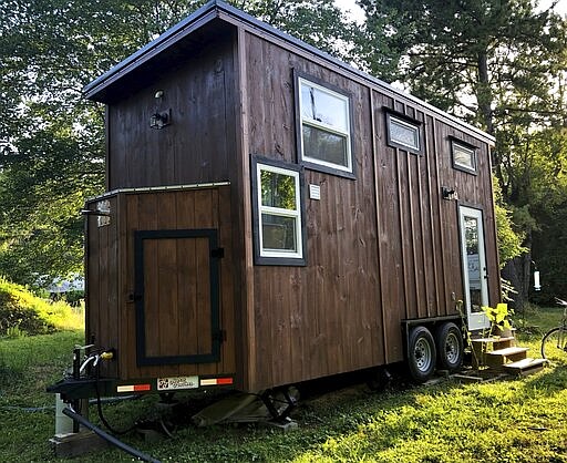 This photo provided by NerdWallet shows the exterior of the tiny home of Annie Colpitts, located in Ashland, Va. Colpitts designed and helped build the home. (Courtesy of Annie Colpitts/NerdWallet via AP)