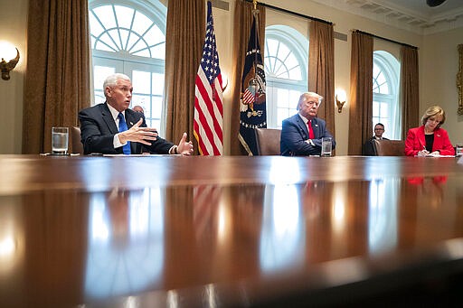 Vice President Mike Pence, left, speaks as President Donald Trump listens, about the coronavirus in the Cabinet Room of the White House during a meeting with representatives of American nurses, Wednesday, March 18, 2020, in Washington. (AP Photo/Alex Brandon)