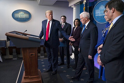 President Donald Trump moves to the side to allow Vice President Mike Pence speak during press briefing with the coronavirus task force, at the White House, Wednesday, March 18, 2020, in Washington. Watching are Veterans Affairs Secretary Robert Wilkie, Administrator of the Centers for Medicare and Medicaid Services Seema Verma, Dr. Deborah Birx, White House coronavirus response coordinator, and Defense Secretary Mark Esper. (AP Photo/Evan Vucci)