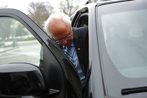 Democratic presidential candidate Sen. Bernie Sanders, I-Vt., departs Capitol Hill in Washington, Wednesday, March 18, 2020, after the Senate passed a second coronavirus response bill. (AP Photo/Patrick Semansky)