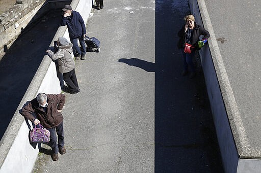 People line-up as they wait to enter in a supermarket in Rome, Wednesday, March 18, 2020. For most people, the new coronavirus causes only mild or moderate symptoms. For some it can cause more severe illness, especially in older adults and people with existing health problems. (AP Photo/Alessandra Tarantino)