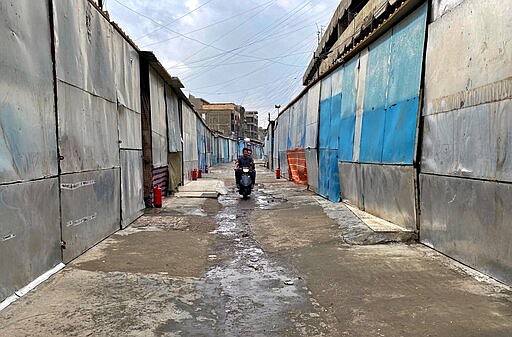 Closed shops are seen in old Baghdad, Iraq, Wednesday, March 18, 2020. Iraq announced a weeklong curfew to help fight the spread of the COVID-19 virus. For most people, the virus causes only mild or moderate symptoms. For some it can cause more severe illness. (AP Photo/Khalid Mohammed)