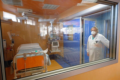 Istituto Clinico Casalpalocco Covid 3 hospital Medical Director Antonio Marchesi wears a mask as he gives a tour for the media of ICU positions set up at the private clinic to tend to coronavirus patients, in Casalpalocco, on the outskirts of Rome, Wednesday, March 18, 2020. For most people, the new coronavirus causes only mild or moderate symptoms. For some it can cause more severe illness, especially in older adults and people with existing health problems. (Mauro Scrobogna/LaPresse via AP)