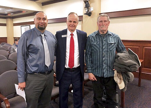 FILE - In this Feb. 11, 2020 file photo, Christopher Tapp, from left, Republican Rep. Doug Ricks and Charles Fain appeared before the Idaho House Judiciary, Rules and Administration Committee in Boise, Idaho, to testify in favor of legislation that would compensate the wrongly convicted. Tapp and Fain combined spent nearly 40 years in Idaho prisons for crimes they didn't commit after being convicted of murder. The House voted unanimously Wednesday, March 18, 2020, to approve the amended measure from the Senate that would pay $60,000 a year for wrongful incarceration and $75,000 per year on death row. (AP Photo/Keith Ridler, File)