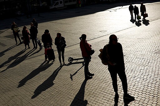 People line up to enter in a supermarket to buy supplies in Brussels, Wednesday, March 18, 2020. Belgium has ordered further lockdown measures starting Wednesday, following in the steps of European neighbours Italy, Spain and France. For most people, the new coronavirus causes only mild or moderate symptoms, such as fever and cough. For some, especially older adults and people with existing health problems, it can cause more severe illness, including pneumonia. (AP Photo/Francisco Seco)