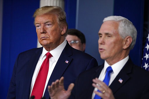 President Donald Trump listens as Vice President Mike Pence speaks during press briefing with the Coronavirus Task Force, at the White House, Wednesday, March 18, 2020, in Washington. (AP Photo/Evan Vucci)