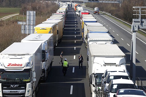 Trucks stand on the highway close to the border between Austria and Hungary near Bruck an der Leitha, Austria, Wednesday, March 18, 2020. Hungary has closed the border due to the new coronavirus outbreak. Only for most people, the new coronavirus causes only mild or moderate symptoms, such as fever and cough. For some, especially older adults and people with existing health problems, it can cause more severe illness, including pneumonia. (AP Photo/Ronald Zak)