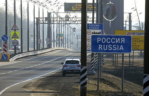 An empty highway to Russia at the Belarus-Russia border near Redki, Belarus, Wednesday, March 18, 2020. Russia announced partially closing the border with Belarus on Monday in a move that elicited criticism from Belarus' leader Alexander Lukashenko. For most people, the new coronavirus causes only mild or moderate symptoms. For some it can cause more severe illness, especially in older adults and people with existing health problems.(AP Photo)