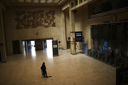 A man looks at train departures boards in a nearly empty Central station in Brussels, Wednesday, March 18, 2020. Belgium has ordered further lockdown measures starting Wednesday, following in the steps of European neighbours Italy, Spain and France. For most people, the new coronavirus causes only mild or moderate symptoms, such as fever and cough. For some, especially older adults and people with existing health problems, it can cause more severe illness, including pneumonia. (AP Photo/Francisco Seco)