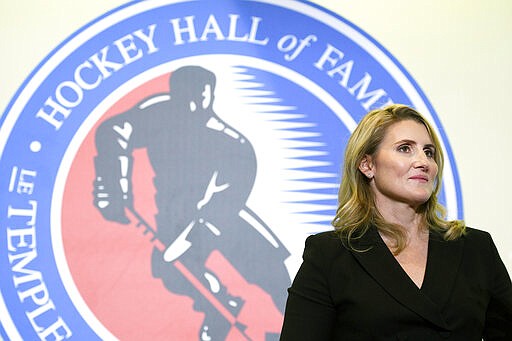 FILE - In this Nov. 15, 2019, file photo, Hockey Hall of Fame inductee Hayley Wickenheiser poses in Toronto. Regional Olympic officials are rallying around the IOC and have backed its stance on opening the Tokyo Games as scheduled. Their support comes one day after direct criticism from athletes amid the coronavirus outbreak. &#147;I think the IOC insisting this will move ahead, with such conviction, is insensitive and irresponsible given the state of humanity,&#148; said Wickenheiser, a four-time Olympic hockey gold medalist from Canada. (Nathan Denette/The Canadian Press via AP, Fle)