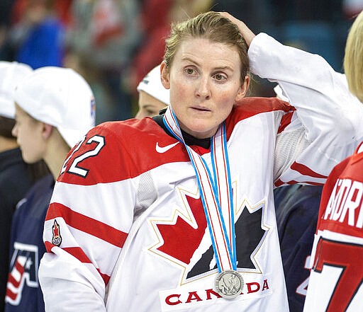FILE - In this April 4, 2016, file photo, Team Canada's Hayley Wickenheiser wears her silver medal after losing 1-0 to Team USA in the gold medal game at the women's world hockey championships in Kamloops, British Columbia. Regional Olympic officials are rallying around the IOC and have backed its stance on opening the Tokyo Games as scheduled. Their support comes one day after direct criticism from athletes amid the coronavirus outbreak. &#147;I think the IOC insisting this will move ahead, with such conviction, is insensitive and irresponsible given the state of humanity,&#148; said Wickenheiser, a four-time Olympic hockey gold medalist from Canada. (Ryan Remiorz/The Canadian Press via AP, File)