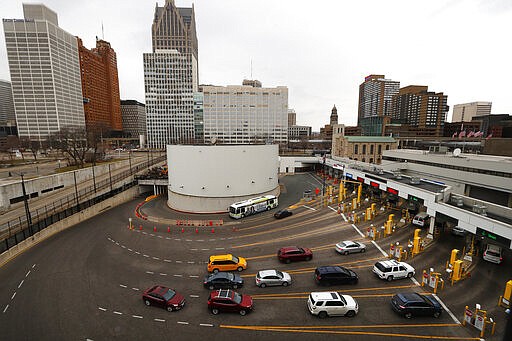 Vehicles enter the United States as a bus drives to Canada in the Detroit-Windsor Tunnel in Detroit, Monday, March 16, 2020. Canadian Prime Minister Justin Trudeau says he is closing his country's borders to anyone not a citizen, an American or a permanent resident amid the coronavirus outbreak. (AP Photo/Paul Sancya)