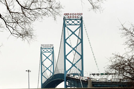 Vehicles move across the Ambassador Bridge between Detroit and Windsor, Ontario, as viewed from Detroit, Monday, March 16, 2020. Canadian Prime Minister Justin Trudeau says he is closing his country's borders to anyone not a citizen, an American or a permanent resident amid the coronavirus outbreak. (AP Photo/Paul Sancya)