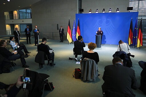 German Chancellor Angela Merkel speaks during a news conference about the coronavirus, where journalists sit spread out, at the chancellery in Berlin, Germany, March 16, 2020. (AP Photo/Markus Schreiber, Pool)