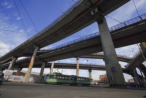 An old tram drives by in an empty street, in Rome, Wednesday, March 18, 2020. For most people, the new coronavirus causes only mild or moderate symptoms. For some it can cause more severe illness, especially in older adults and people with existing health problems. (AP Photo/Andrew Medichini)