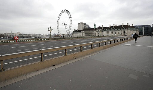 An empty Westminster Bridge in London, Wednesday, March 18, 2020. For most people, the new coronavirus causes only mild or moderate symptoms, such as fever and cough. For some, especially older adults and people with existing health problems, it can cause more severe illness, including pneumonia.(AP Photo/Kirsty Wigglesworth)