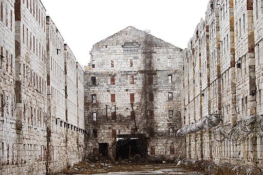 In this Feb. 13, 2020 photo, stone walls are all that remain of a former cell block at Sing Sing Correctional Facility in Ossining, N.Y. The hollowed-out building used to house cells for 1,200 men on six tiers and runs well longer than a football field. It was constructed by inmates who were dropped off at the Hudson River landing in 1825 and ordered to mine limestone from the hillside for what would become their prison. It was used for housing for about a century while the prison grew up around it. (AP Photo/Mark Lennihan)