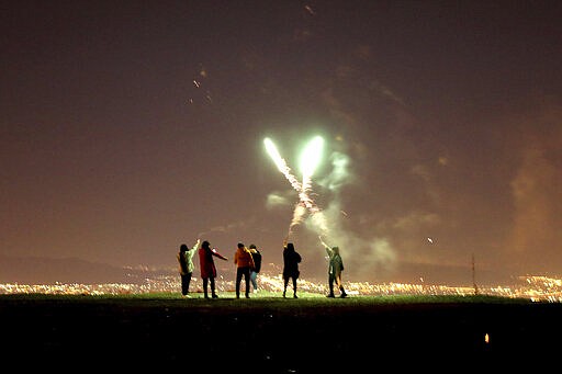 In this Tuesday, March 17, 2020 photo, Iranians light fireworks during a celebration, known as &quot;Chaharshanbe Souri,&quot; or Wednesday Feast, marking the eve of the last Wednesday of the solar Persian year, in Tehran, Iran. (AP Photo/Ebrahim Noroozi)