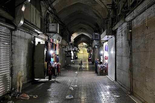 In this Tuesday, March 17, 2020, photo, mostly closed Tehran's Grand Bazaar is seen in Iran. The new coronavirus ravaging Iran is cutting into celebrations marking the Persian New Year, known as Nowruz. (AP Photo/Ebrahim Noroozi)