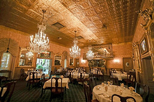 This Tuesday, March 17, 2020 photo shows the empty dining room of the Double Eagle Steakhouse during what would usually be the lunch rush in Mesilla, N.M. Restaurants and bars sat empty this week after New Mexico Gov. Michelle Lujan Grisham ordered them to serve takeout only amid the novel coronavirus outbreak. (Nathan J. Fish/Las Cruces Sun-News via AP)