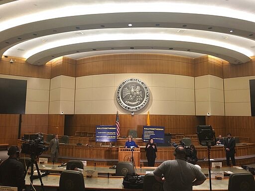 New Mexico Gov. Michelle Lujan Grisham confirms a new coronavirus infection that has no apparent link to travel on Wednesday, March 18, 2020, during a news conference on the floor of the state House of Representatives in Santa Fe, N.M. She also issued orders to limit the spread of the contagion by restricting restaurants to take-out service and closing down movie theaters, gyms, spas and shopping malls. New Mexico is bracing for the possible spread of coronavirus to some of America's most remote, impoverished communities, as hospitals across the state prepare to convert operating rooms into acute respiratory care units. (AP Photo/Morgan Lee)