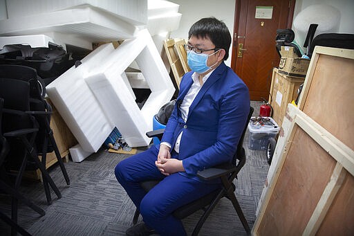 In this March 18, 2020 photo, Liu Zhiyong, the CEO of ZhenRobotics, speaks during an interview at the company's offices in Beijing. While other industries struggle, Liu  says China&#146;s virus outbreak is boosting demand for his knee-high, bright yellow robots to deliver groceries and patrol malls looking for customers who fail to wear masks. (AP Photo/Mark Schiefelbein)