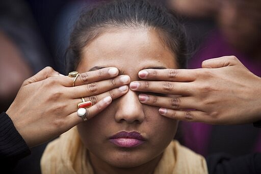 FILE- In this Dec. 15, 2014, file photo, an Indian girl participates in a street play to create awareness on violence against women during a protest ahead of the second anniversary of the deadly gang rape of a 23-year-old physiotherapy student on a bus, in New Delhi, India. Four men sentenced for capital punishment for the 2012 gang-rape of a 23-year-old physiotherapy student on a moving bus in New Delhi have been executed. The men were hanged Friday morning, March 20, 2020, at Tihar Jail in New Delhi. (AP Photo/Tsering Topgyal, File)