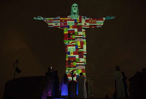 Rio's Christ the Redeemer statue is lit up with the flags of countries currently afflicted by the new coronavirus in Rio de Janeiro, Brazil, March 18, 2020. (AP Photo/Silvia Izquierdo)