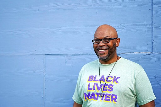 In this March 18, 2020, photo, Ashton P. Woods poses for a photograph in Houston. Woods launched a petition asking Texas Gov. Greg Abbott to suspend rent, mortgage and utility payments. &#147;For the most part, if you're black and brown, you're getting it a lot harder with the systemic racism and xenophobia,&quot; Woods said. &quot;Now, we have a pandemic where people are scared to go to the doctor, let alone miss work, because they still have to pay their rent.&#148;(AP Photo/David J. Phillip)