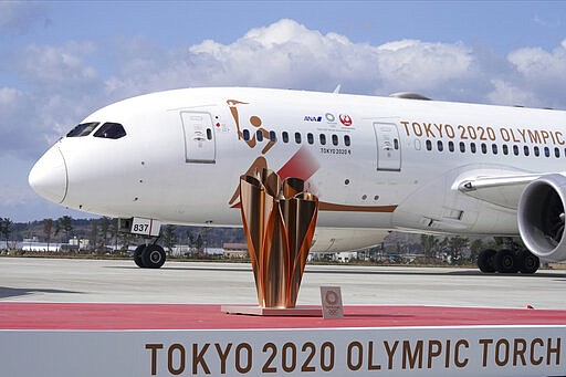 A plane carrying the Olympic flame arrives before Olympic Flame Arrival Ceremony at Japan Air Self-Defense Force Matsushima Base in Higashimatsushima in Miyagi Prefecture, north of Tokyo, Friday, March 20, 2020. The Olympic flame from Greece is set to arrive in Japan even as the opening of the the Tokyo Games in four months is in doubt with more voices suggesting the games should to be postponed or canceled because of the worldwide virus pandemic. (AP Photo/Eugene Hoshiko)