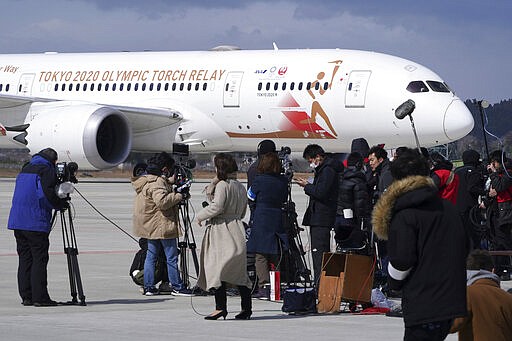 A plane carrying the Olympic flame arrives before Olympic Flame Arrival Ceremony at Japan Air Self-Defense Force Matsushima Base in Higashimatsushima in Miyagi Prefecture, north of Tokyo, Friday, March 20, 2020. The Olympic flame from Greece is set to arrive in Japan even as the opening of the the Tokyo Games in four months is in doubt with more voices suggesting the games should to be postponed or canceled because of the worldwide virus pandemic. (AP Photo/Eugene Hoshiko)