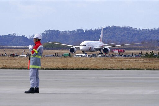 A plane arrives before Olympic Flame Arrival Ceremony at Japan Air Self-Defense Force Matsushima Base in Higashimatsushima in Miyagi Prefecture, north of Tokyo, Friday, March 20, 2020. The Olympic flame from Greece is set to arrive in Japan even as the opening of the the Tokyo Games in four months is in doubt with more voices suggesting the games should to be postponed or canceled because of the worldwide virus pandemic. (AP Photo/Eugene Hoshiko)