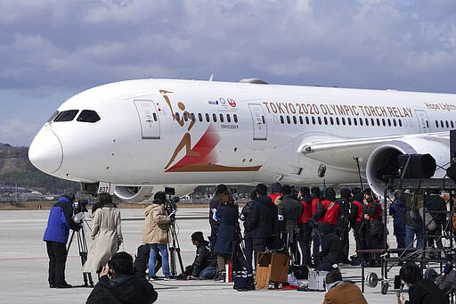 A plane carrying the Olympic flame arrives before Olympic Flame Arrival Ceremony at Japan Air Self-Defense Force Matsushima Base in Higashimatsushima in Miyagi Prefecture, north of Tokyo, Friday, March 20, 2020. The Olympic flame from Greece is set to arrive in Japan even as the opening of the the Tokyo Games in four months is in doubt with more voices suggesting the games should to be postponed or canceled because of the worldwide virus pandemic. (AP Photo/Eugene Hoshiko)