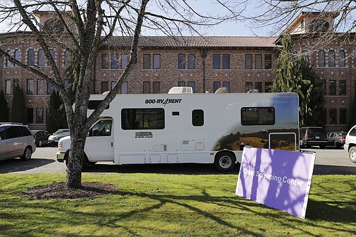 A rented RV serves as a screening center for attorneys and others visiting courtroom facilities at Western State Hospital, Thursday, March 19, 2020, in Lakewood, Wash. A patient and a worker at the facility, Washington state's largest psychiatric hospital, have tested positive for the new coronavirus. (AP Photo/Ted S. Warren)