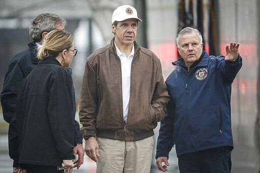 New York Governor Andrew Cuomo tours a COVID-19 infection testing facility at Glen Island Park, Friday, March 13, 2020, in New Rochelle, N.Y.  State officials have set up a &#147;containment area&#148; in the New York City suburb, where schools and houses of worship are closed within a 1-mile radius of a point near a synagogue where an infected person with coronavirus had attended events. State officials stress it is not a lockdown. The vast majority of people recover from the new coronavirus. According to the World  Health Organization, most people recover in about two to six weeks, depending on the severity of the illness.  (AP Photo/John Minchillo)