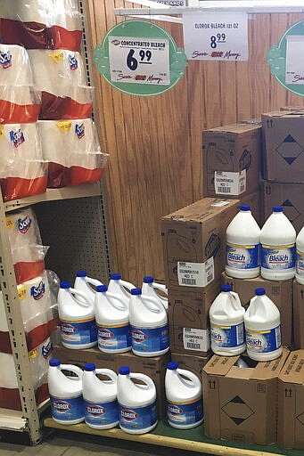 This March 10, 2020 photo made by an investigator with the Michigan Attorney General's Office shows gallons of Clorox bleach on display priced at $8.99 each at a Menards store in Jackson, Mich. A price sticker on an empty shelf elsewhere in the store listed it as $4.47. (Michigan Attorney General's Office via AP)