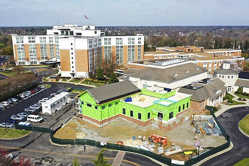 This Thursday March 19 , 2020 aerial photo, shows the grounds at Westminster Canterbury Richmond retirement home in Richmond, Va. The retirement home announced earlier this week that a patient was being treated at a hospital for coronavirus after returning from travel to Florida. Virginia health officials on Thursday confirmed at least the second case of a person infected with the new coronavirus in an assisted living facility, this one in the Washington suburbs of Falls Church, Va. (AP Photo/Steve Helber)