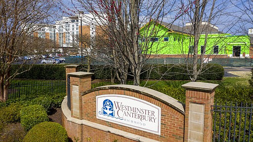 This Thursday March 19 , 2020 photo, shows the entrance to Westminster Canterbury Richmond retirement home in Richmond, Va. The retirement home announced earlier this week that a patient was being treated at a hospital for coronavirus after returning from travel to Florida. Virginia health officials on Thursday confirmed at least the second case of a person infected with the new coronavirus in an assisted living facility, this one in the Washington suburbs of Falls Church, Va. (AP Photo/Steve Helber)