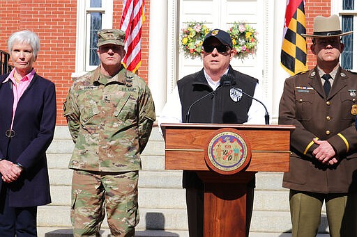 Maryland Gov. Larry Hogan announces an order to close bars, restaurants, gyms and move theaters in the state in response to coronavirus during a news conference at the governor's mansion on Monday, March 16, 2020 in Annapolis, Md. From left is Deputy Health Secretary Fran Phillips, Maj. Gen. Timothy Gowen, the adjutant general of the Maryland National Guard, Hogan, and Superintendent of the Maryland State Police Woodrow Jones. (AP Photo/Brian Witte)