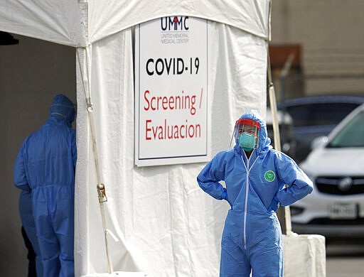 Healthcare professionals prepare to begin testing at a drive-thru testing site for COVID-19 at United Memorial Medical Center Thursday, March 19, 2020, in Houston. For most people, the coronavirus causes only mild or moderate symptoms, such as fever and cough. For some, especially older adults and people with existing health problems, it can cause more severe illness, including pneumonia. (AP Photo/David J. Phillip)