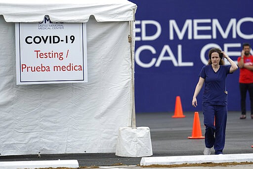 Health care professionals prepare to open drive-thru testing for COVID-19 at United Memorial Medical Center Thursday, March 19, 2020, in Houston. For most people, the coronavirus causes only mild or moderate symptoms, such as fever and cough. For some, especially older adults and people with existing health problems, it can cause more severe illness, including pneumonia. (AP Photo/David J. Phillip)