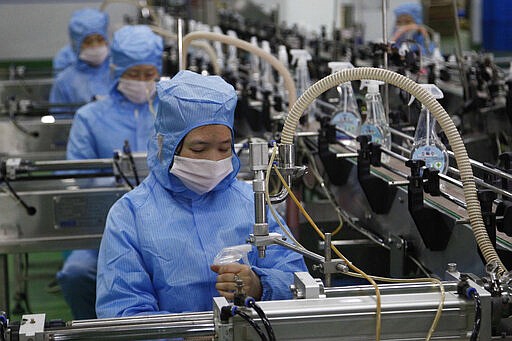 Workers of the Ryongaksan Soap Factory make disinfectant in Pyongyang, North Korea Thursday, March 19, 2020. North Korea has been engaged in an intense campaign to guard against COVID-19, though it hasn&#146;t officially reported any cases of infection. For most people, the new coronavirus causes only mild or moderate symptoms. For some it can cause more severe illness. (AP Photo/Jon Chol Jin)