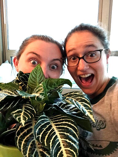 In this May 2019 photo, Molly Sprayregen, right, and her fianc&eacute; Meredith Bennett-Swanson celebrate the purchase of one of their new house plants in Chicago, Ill. (Molly Sprayregen via AP)