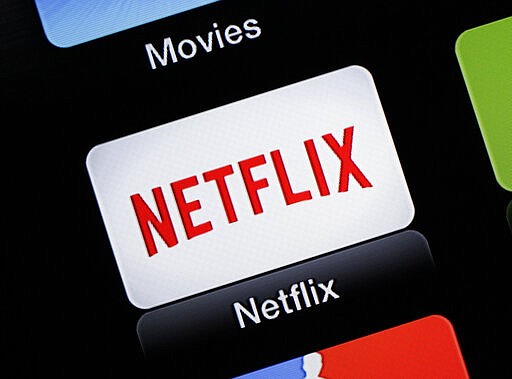 FILE - This June 24, 2015, file photo, shows the Netflix Apple TV app icon, in South Orange, N.J. Netflix reports financial results on Monday, April 18, 2016. Sports are on hold, movie theaters are closed and so are amusement parks. But Americans held captive at home by the coronavirus can turn to Netflix, Amazon, Hulu and other streaming services, outliers in an entertainment industry otherwise brought to an unprecedented standstill. (AP Photo/Dan Goodman, File)