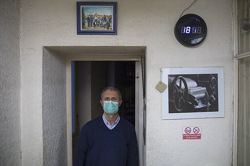 In this photo taken Monday March 16 2020, fourth generation soap maker Serge Bruna poses for a portrait in his family owned Licorne soap factory in Marseille, southern France. Amid the rapid outbreak of the new coronavirus across Europe, the hallmark Marseille tradition of soap-making is enjoying a renaissance, as the French public rediscovers this essential local product. As French shops were ordered closed this week in a bid to counter the new coronavirus, Bruna's Savonnerie de la Licorne now runs its operations only for delivery, supplying pharmacies across France and handling individual orders placed through its online store. (AP Photo/Daniel Cole)