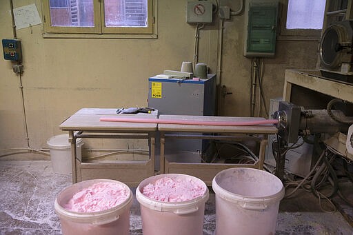 In this photo taken Monday March 16 2020, uncut bars of soap are pictured at the Licorne soap factory in Marseille, southern France. Amid the rapid outbreak of the new coronavirus across Europe, the hallmark Marseille tradition of soap-making is enjoying a renaissance, as the French public rediscovers this essential local product. As French shops were ordered closed this week in a bid to counter the new coronavirus, Bruna's Savonnerie de la Licorne now runs its operations only for delivery, supplying pharmacies across France and handling individual orders placed through its online store. For most people, the new coronavirus causes only mild or moderate symptoms. For some it can cause more severe illness. (AP Photo/Daniel Cole)